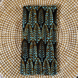 Phone case with feather pattern on a woven surface