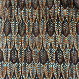 Patterned fabric with feather design on a brown background