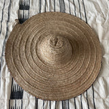 Woven mat on a striped fabric surface