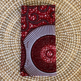 Red and white patterned fabric on a woven mat