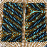 Two fabric swatches with a leaf pattern on a woven surface