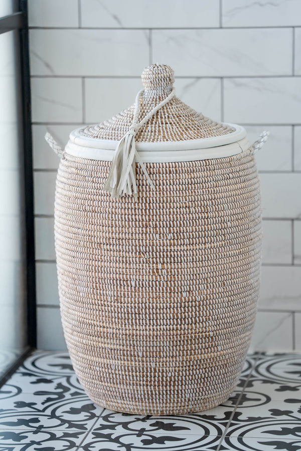 Round white handwoven basket with lid, leather trim and tassel, artisan-made in Africa. 