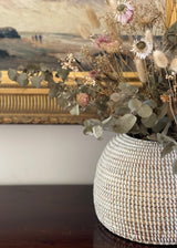 Close up of handwoven takh basket styled with dried flowers