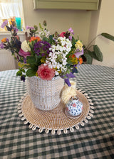 Handwoven Senegalese basket vase styled with  fresh flowers 