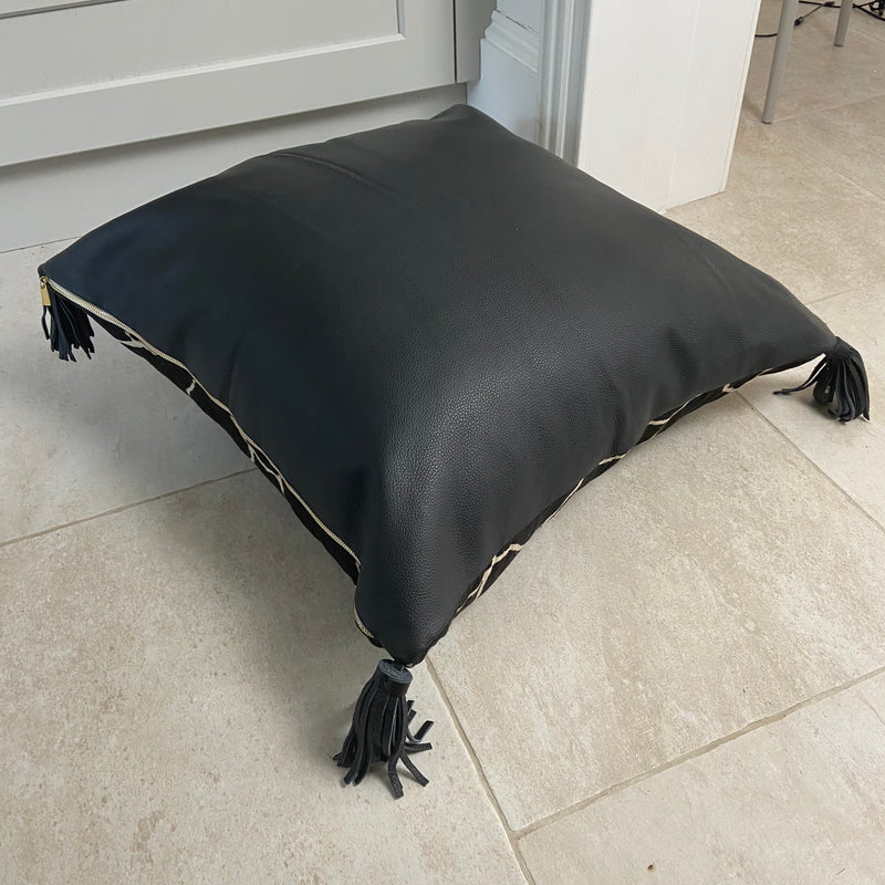 Black Floor Cushion with Soft Leather Back and Tassels. The Tortoise