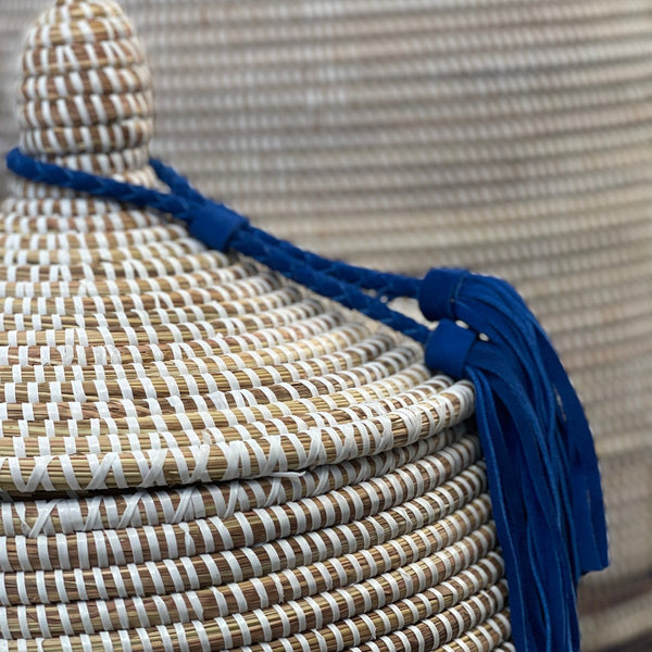 White basket with blue tassel