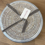 handwoven white placemat with brushed silver trim and emmela label detail